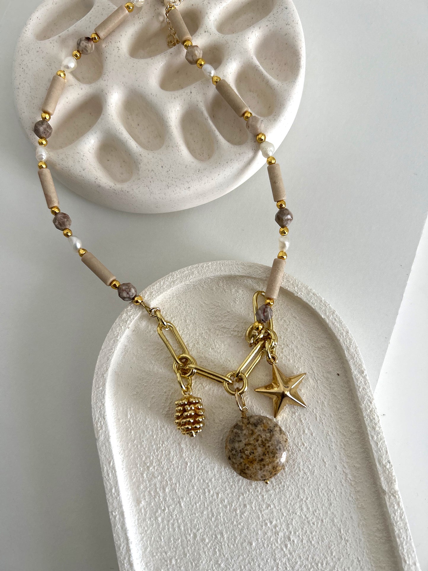 Nude stones necklace with golden charms