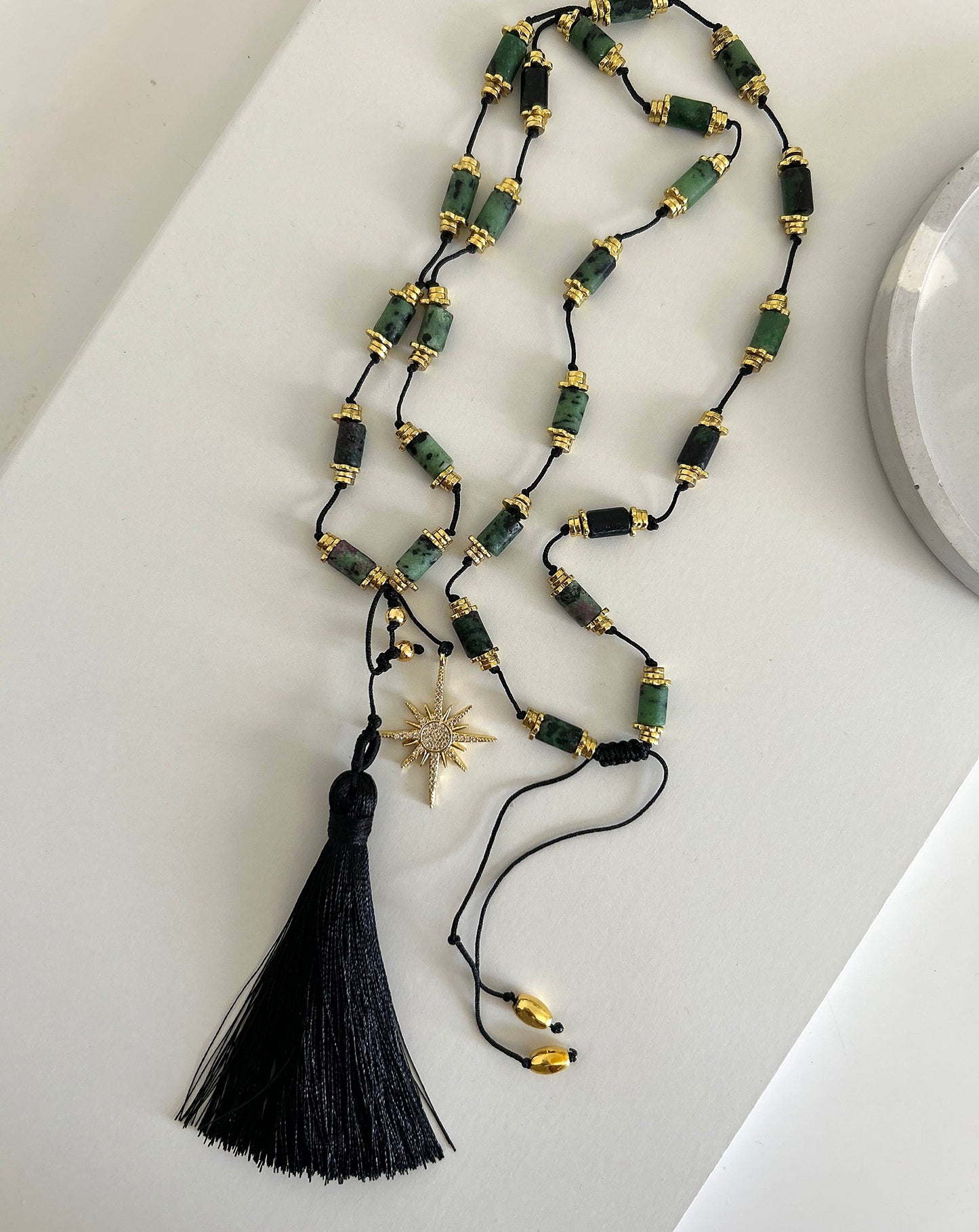 Black tassel with green stones